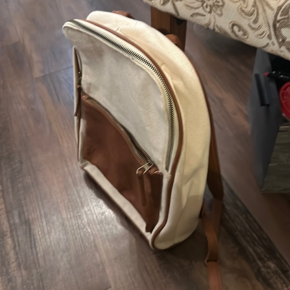 Canvas and brown backpack with laptop protection inside